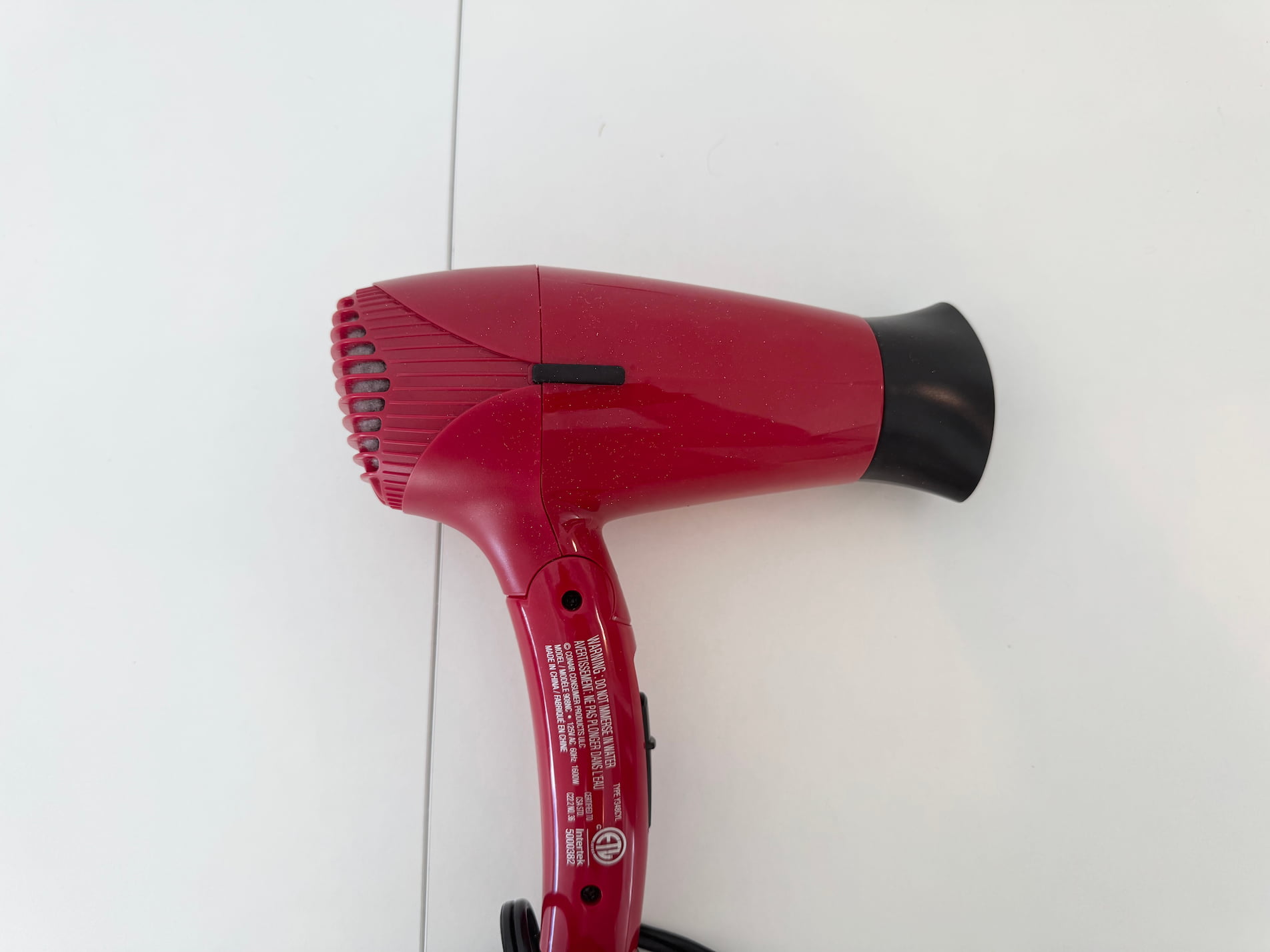 The sound of a hair dryer turning on and changing airflow from low to high